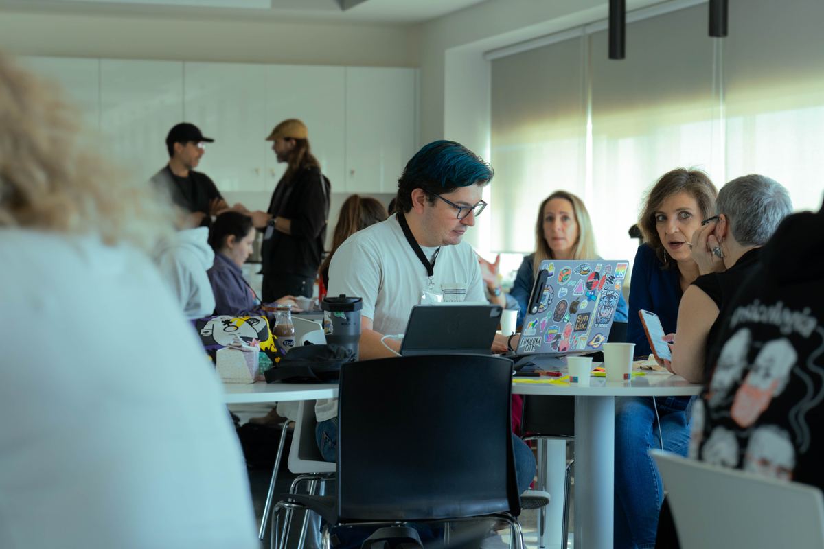 The hackathon room full of teams at work